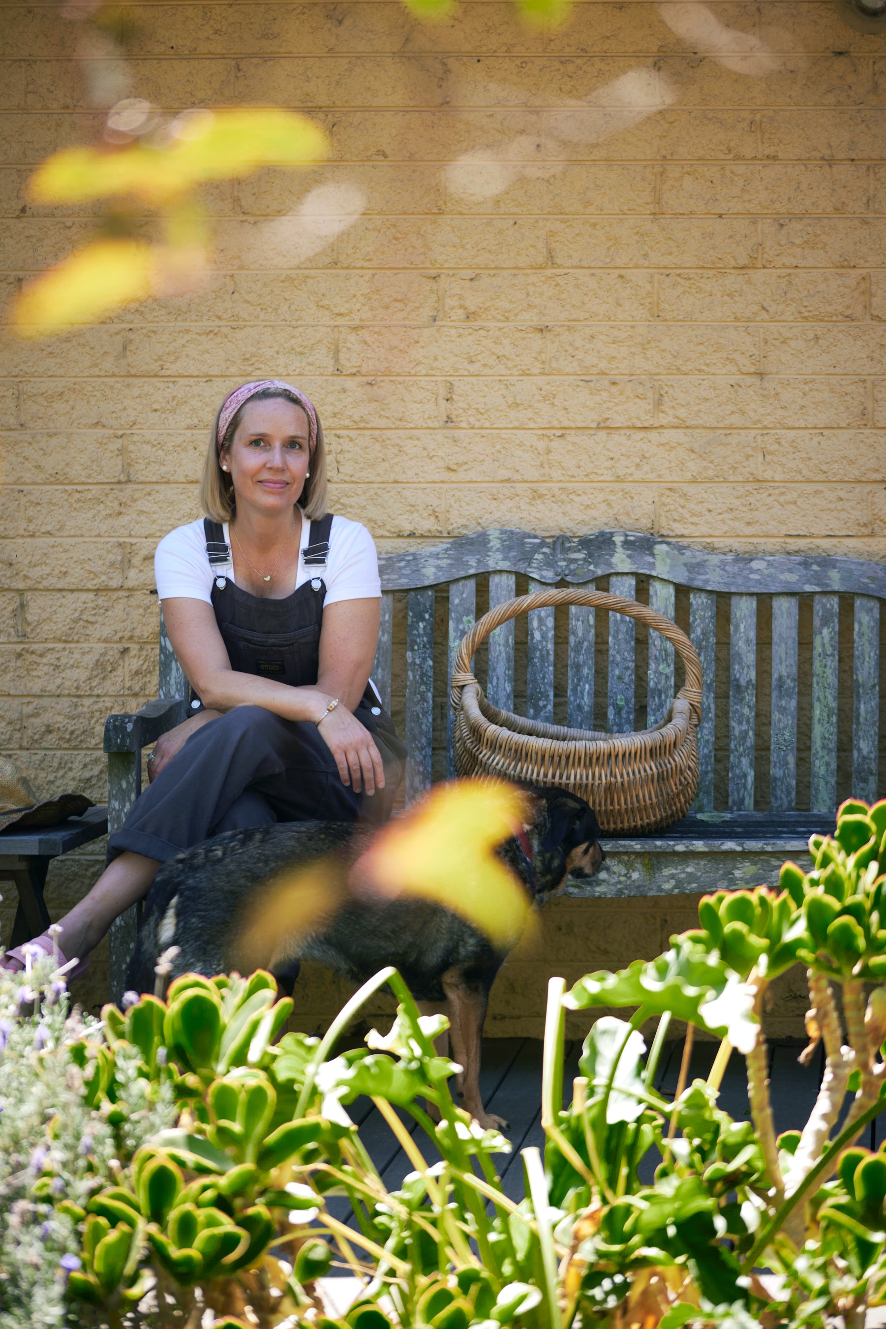 Pollys Farm founder Kimberley Kidger on bench seat in garden